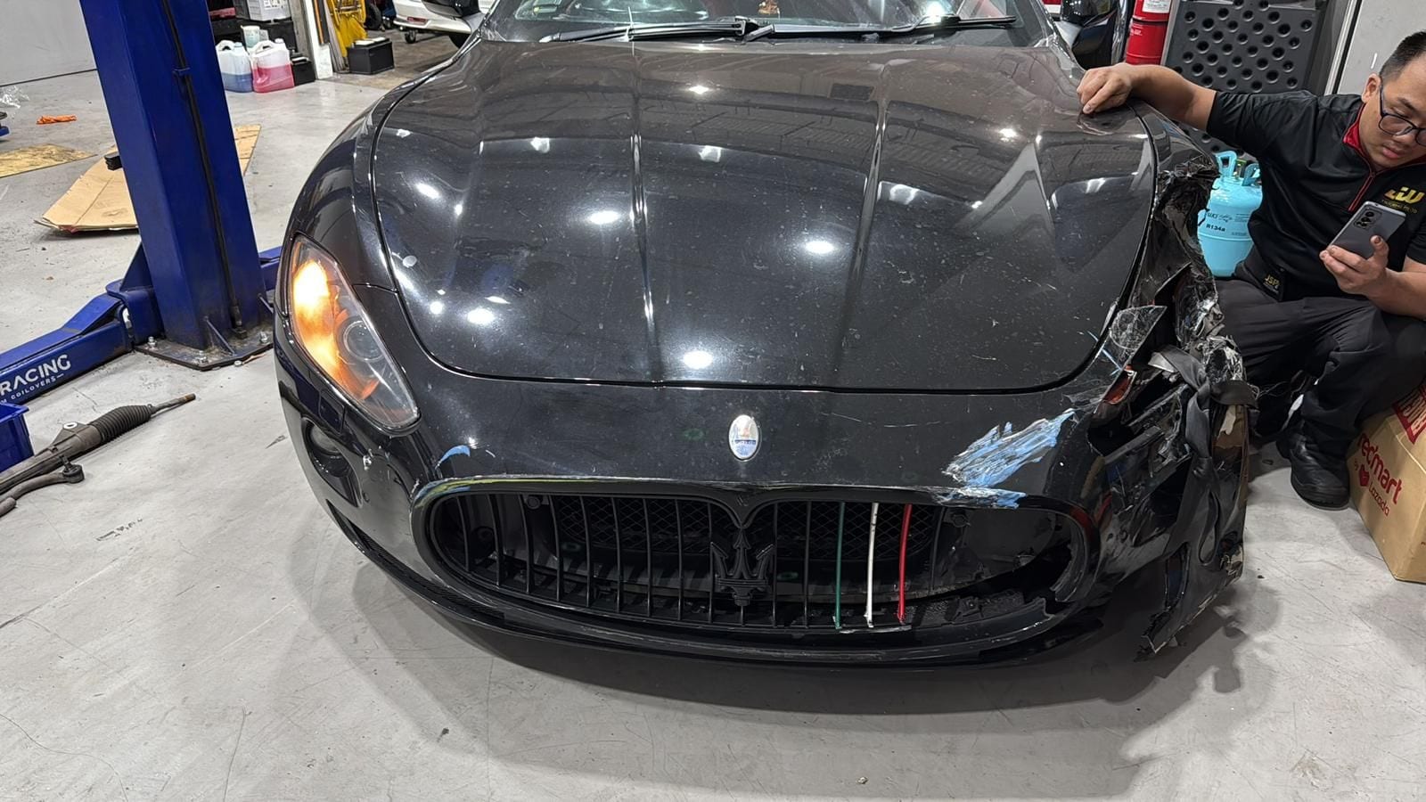 Front-end impact on a Maserati documented in the JW Motoring Kaki Bukit workshop — photos and notes for post-accident assessment and claim support in Singapore