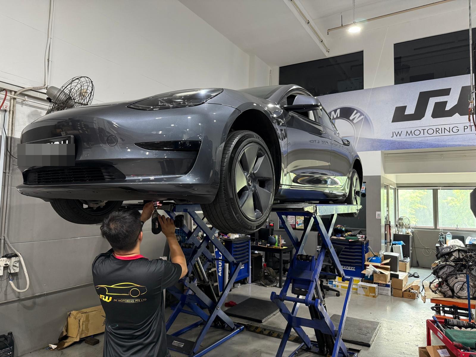 Tesla Model 3 raised on a lift for EV and hybrid maintenance at JW Motoring Kaki Bukit, Singapore